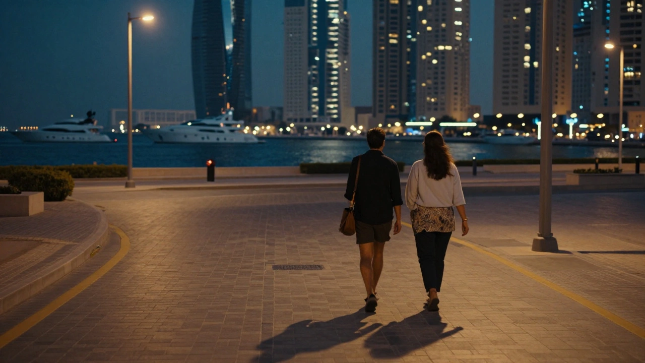 A couple walks peacefully down a quiet Dubai Marina street at 4 a.m., city lights glowing softly.