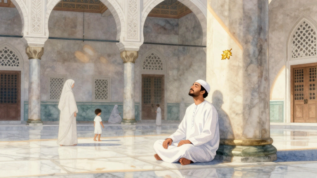 A man in a white thobe sitting quietly in the mosque courtyard, sunlight streaming through ornate arches.